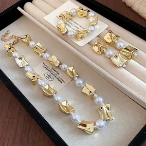 Retro gold-tone jewelry set with irregular metal pieces and pearls in display box