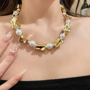 Elegant vintage style necklace featuring white pearls and irregular crushed gold beads on model