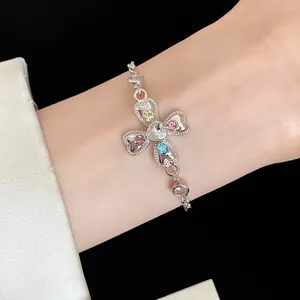 Detailed macro view of heart-shaped flower bracelet with vibrant colorful rhinestones on wrist
