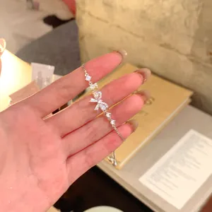 Close-up of an elegant silver bow bracelet featuring sparkling cubic zirconia stones