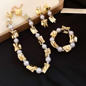 Detail view of retro pearl jewelry set with irregular gold-tone beads and necklace
