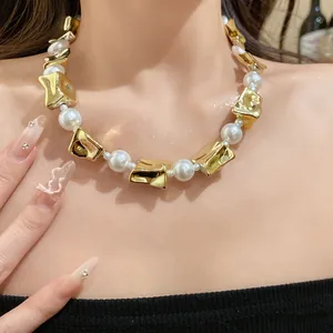 Detailed close-up of a vintage pearl necklace with chunky irregular gold beads on neck