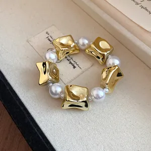Macro view of a luxury vintage court style gold and pearl beaded bracelet in box