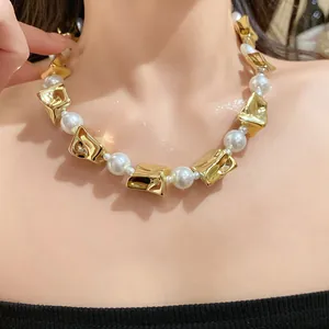 Close-up view of a vintage pearl and irregular gold metal statement choker on a model's collarbone