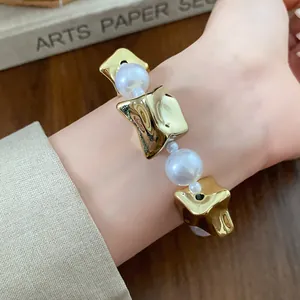 Close-up of elegant vintage pearl bracelet with gold irregular beads on a woman wrist