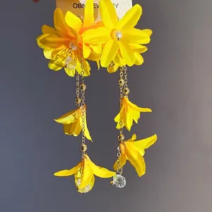 Elegant yellow fabric flower earrings with pearls and long tassels on silver needles