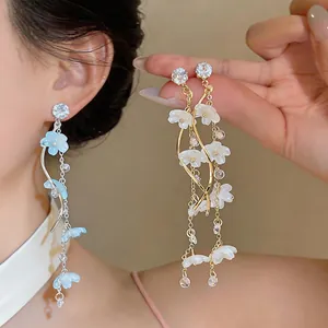 Detailed view of sweet resin flower tassel earrings with shimmering cubic zirconia