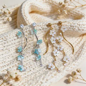 Detailed view of elegant resin flower tassel earrings with sparkling clear zircons.