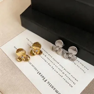 Elegant minimalist 3-petal flower stud earrings with crystal center in gold and silver finishes