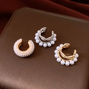 Detail showing elegant double-layer zircon and pearl ear cuffs in gold and silver finish