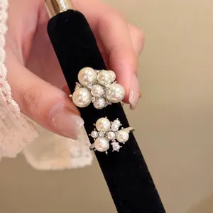 Close-up detail of French vintage pearl cluster rings with elegant glossy finish for women