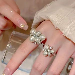 Exquisite close-up detail of French vintage pearl flower cluster rings for women