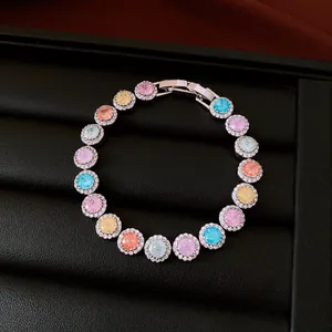 Detailed macro view of silver-plated bracelet with colorful round zircons and halos