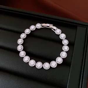 Macro detail of a sparkling round cubic zirconia gold-plated bracelet in a black box