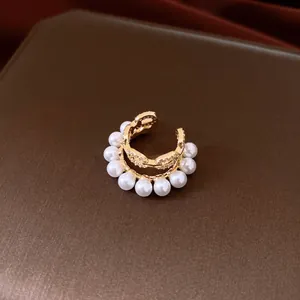 Close-up of double-layer zircon and pearl ear cuff with elegant gold pig nose design