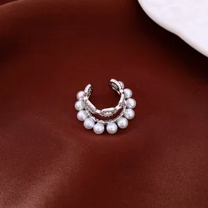 Close-up of a French style double-layered ear cuff with white pearls and zircons