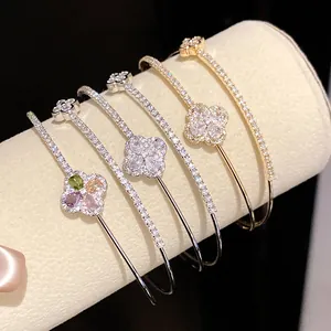 Close-up view of 18k gold plated clover bracelets adorned with sparkling cubic zirconia stones.