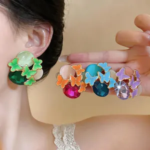 Detailed view of colorful forest style butterfly stud earrings with rhinestones