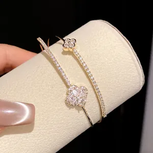 Close-up of 18k gold plated double-layer bracelet with shimmering zircon flower charms