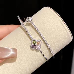 Close-up of 18k gold plated double-layer bracelet with colorful zircon flower motifs.