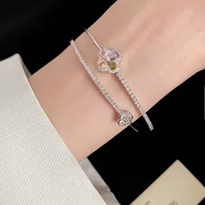 Close-up detail of double-layered 18k gold plated bracelet with colorful zircon flower