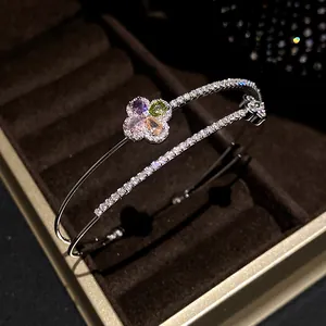 Macro view of double-layer bracelet featuring multi-colored zircon flower motif.