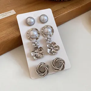 Elegant vintage silver metal earring set with pearls and floral drop designs for women