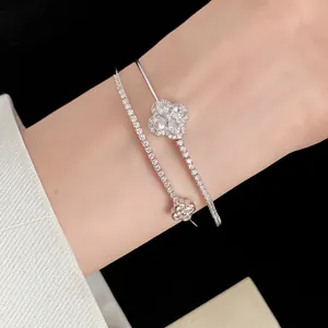 Detailed view of elegant double-layered bangle with sparkling clover flower design