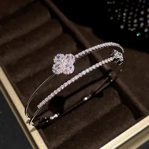 Close-up of a luxury double-layer silver bracelet with shimmering zircon flower motifs