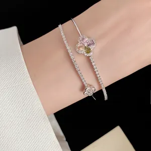 Detail view of an elegant double-layer flower bangle featuring vibrant colorful zirconia stones.
