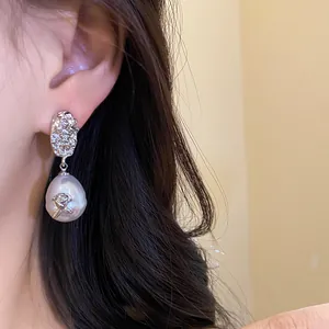 French vintage style baroque pearl drop earrings with a silver rose detail for women