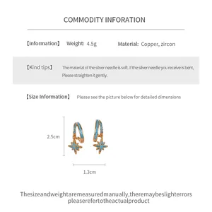 Detail view of gold star dangle earrings showing dimensions, weight and material info