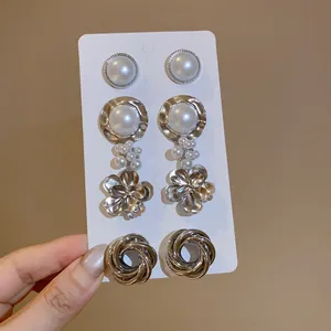 Detail view of 4-pair silver metal earring set with pearls on display card