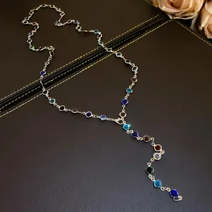 Close-up of vintage palace style necklace with colorful glass beads on leather background
