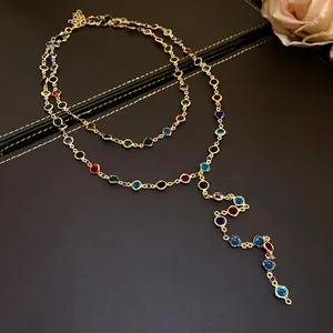 Close-up of a vintage double-layered Y-shaped necklace with colorful glass beads and gold finish