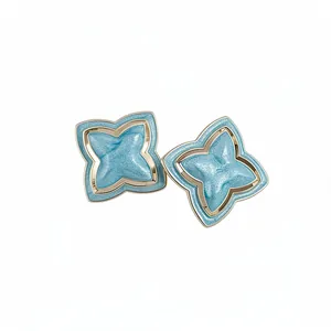 Elegant vintage star flower stud earrings in light blue glitter enamel finish with gold borders