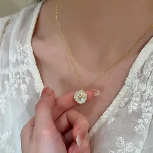 Elegant round pendant necklace with star moon zircon design on model wearing lace.