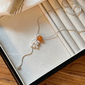 Elegant grape cluster necklace with tiger eye and pearl beads on a silver snake chain.