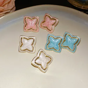 Detail shot of vintage drip oil star flower earrings in pink, blue and white colors