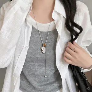Detail view of a Korean-style grape cluster necklace with pearls and tiger's eye bead.