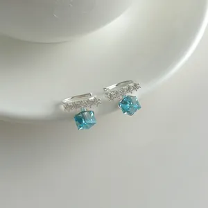 Detailed close-up view of elegant blue cube crystal ear clips with sparkling stones