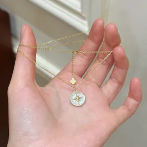 Detailed shot of a gold-toned necklace with a star and moon zircon pendant