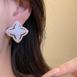 Vintage starburst flower stud earring with enamel and glitter finish
