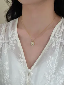 Close-up of a delicate gold-tone round necklace with star motif and cubic zirconia detail