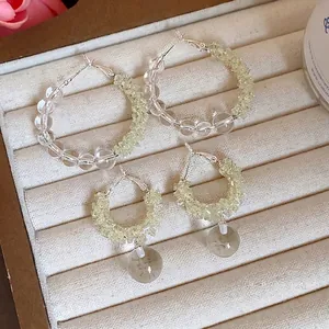 Elegant clear and yellow glass beaded hoop earrings set displayed on a jewelry tray