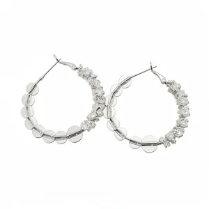 Elegant silver hoop earrings featuring clear glass beads and circular metallic discs