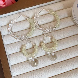 Detail view of elegant glass beaded hoop earrings and drop earrings on jewelry tray