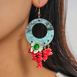 Detail view of colorful marble geometric flower tassel earrings for women.