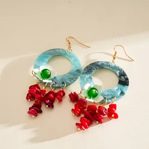 Dopamine-style swirled blue acrylic hoop earrings with white flowers and red stone fringe