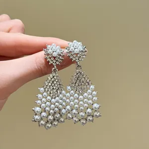 Detail view of elegant French vintage earrings with pearls and brilliant zircons